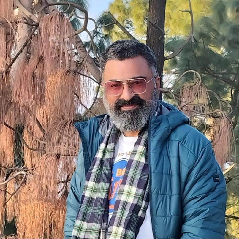 Sachin Thacker — founder of Morni Hills Retreat & Heaven, standing among the Morni Hills pine trees